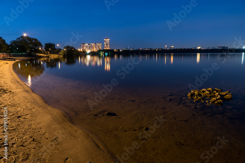 evening river cityscape with water reflections photo
