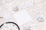 Christmas composition. Card mockup with white decorations on white wood background. Christmas, winter, new year concept. Flat lay, top view, copy space