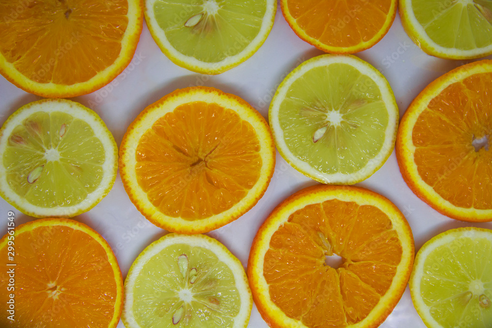 Obraz premium slices of orange and lemon on white, looks like a background