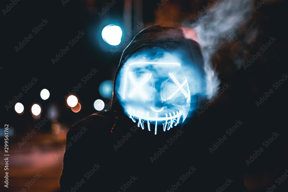 A scary mask covered in smoke.