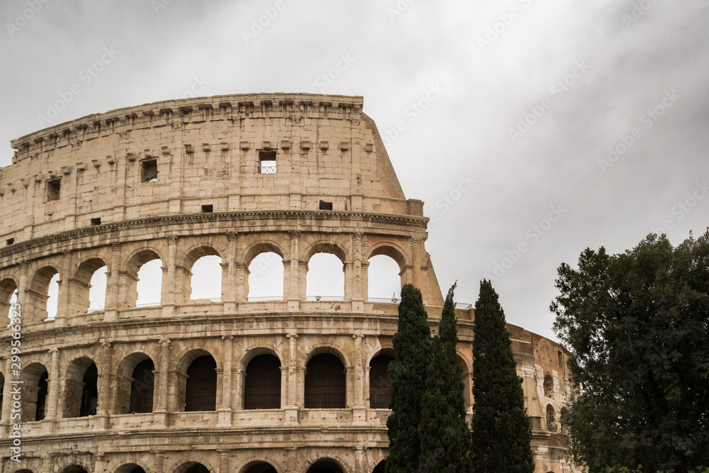 Colosseum in Rome with cloudy sky on a rainy day