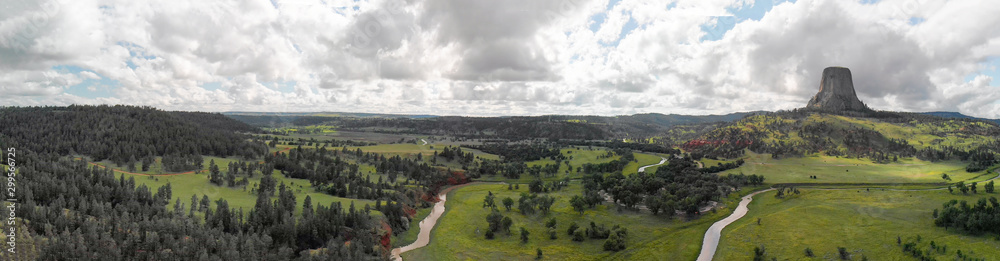 Panoramic aerial view of Devils Tower National Monument at summer sunset, Wyoming from drone perspective Panoramic aerial view of Devils Tower National Monument at summer sunset, Wyoming from drone perspective