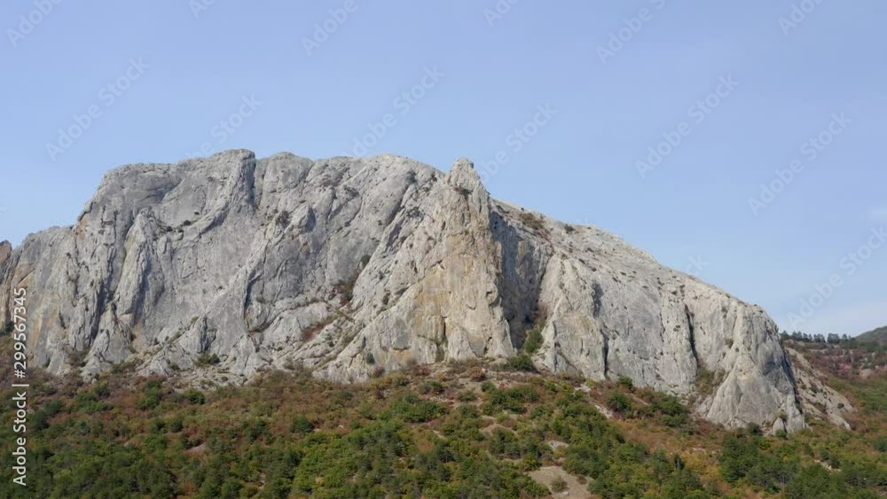 Landscape of mountain range on background blue sky. Aerial shot of rocky mountain peak. Landscape of mountain range on background blue sky. Aerial shot of rocky mountain peak.