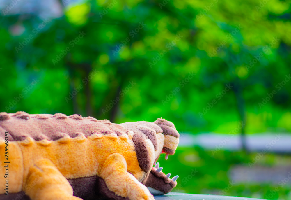 Crocodile doll placed on car leather