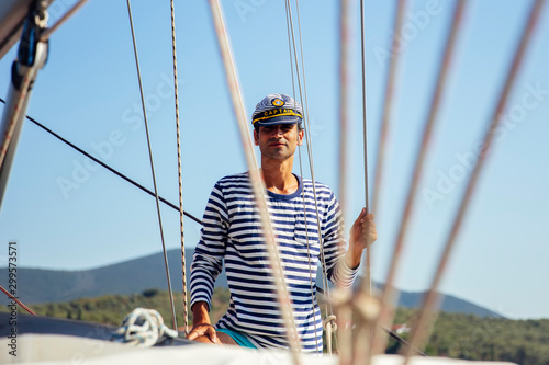 Handsome young man on a sai...