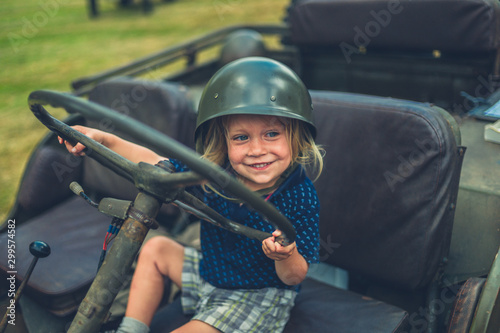 Obraz na plátně Little toddler pretending to drive military vehicle