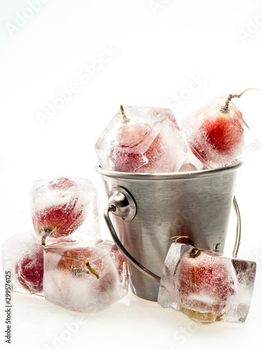 Grape inside ice on white background
