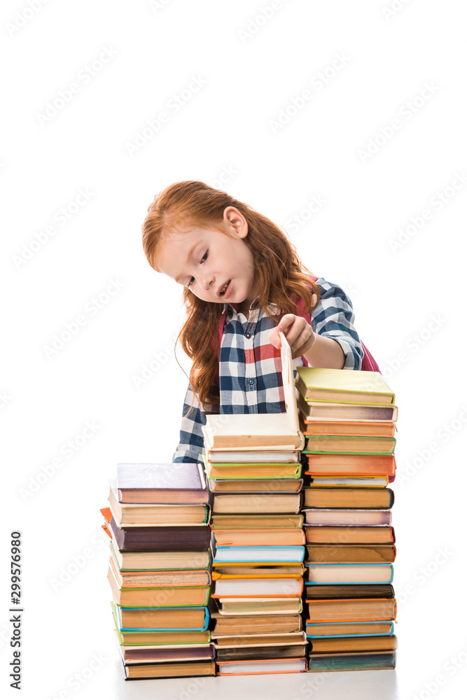 cute redhead pupil looking at books isolated on white cute redhead pupil looking at books isolated on white