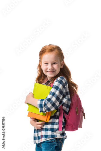 cheerful redhead pupil holding books isolated on white