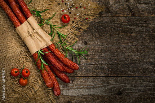Thin Dry Smoked Polish Sausage on Wooden Background. Selective focus. photo