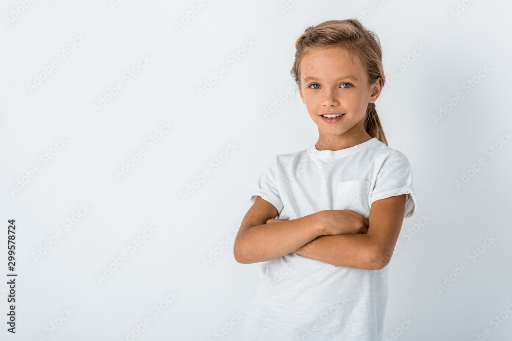 happy child standing with crossed arms on white happy child standing with crossed arms on white