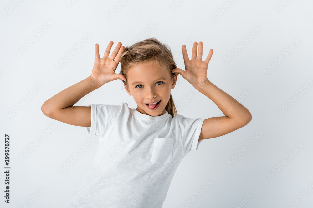 happy kid sticking out tongue and looking at camera on white happy kid sticking out tongue and looking at camera on white
