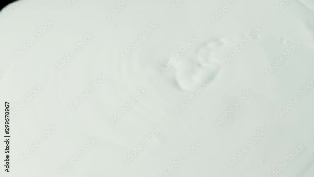 White Paint Poured Onto Black Surface White Paint Poured Onto Black Surface
