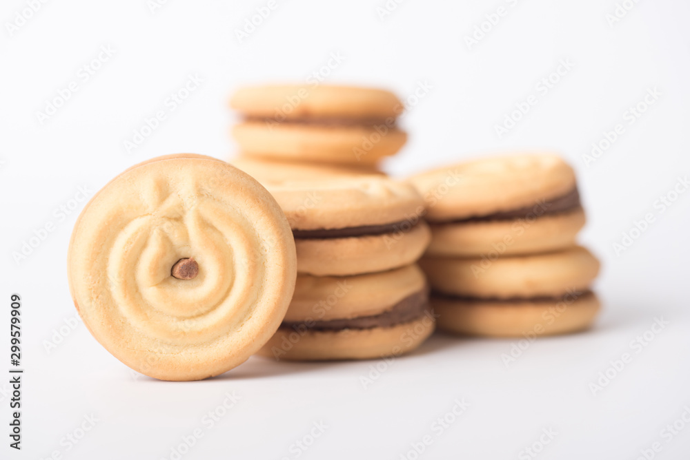 Cookies stuffed with coffee cream stacked on a white background.