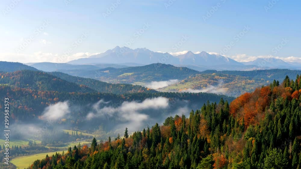 Time lapse footage of beautiful autumn landscape with High Tatras Mountains in background, Slovakia.