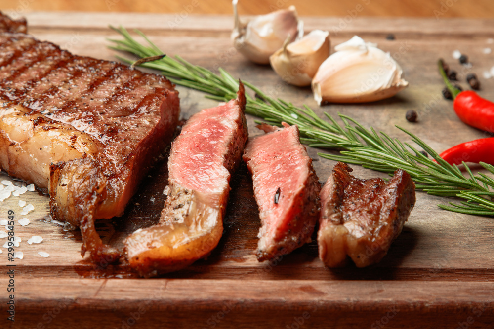 steak from beef, steak with vegetables, proper nutrition, healthy food,  a piece of boiled pork on a wooden board, presentation and serving, rustic style, vegetables for meat, 