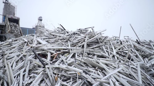 Garbage pile lies in courtyard of processing plant, plastic windows are piled in pile, broken window profile, plastic processing, environmental cleaning, waste-free production, hazardous materials