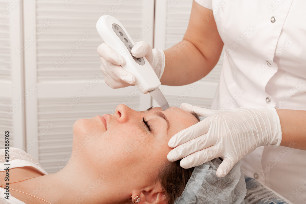 Ultrasonic scrabbing. Cosmetology and facial skin care. Treatment, face cleaning