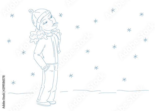 cute girl with cap and scarf catching snowflakes with her tongue