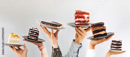 Concept for cafe or bakery with desserts: plates with different cakes in people's hands, place for your text