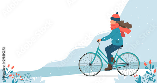 Fototapeta Naklejka Na Ścianę i Meble -  Girl riding bike in the park in winter. Cute vector illustration in flat style.