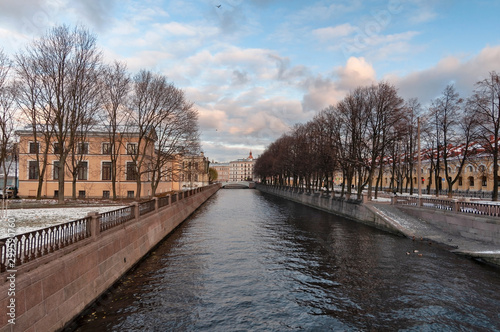 Griboedov Canal Embankment and Krasnogvardeisky Bridge in the center of St. Petersburg in late autumn in the evening sun © Volnnata