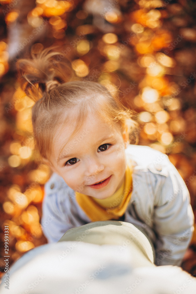 little pretty girl posing for a photo while walking with her parents in autumn park, an infinitely happy and joyful child, selective focus, noise effect little pretty girl posing for a photo while walking with her parents in autumn park, an infinitely happy and joyful child, selective focus, noise effect