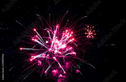 Colorful fireworks in the sky on black background. Festive colorful fireworks in the night sky.