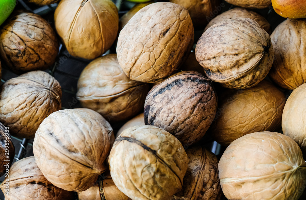 The harvest of walnuts. Ripe walnuts in a shell. The harvest of walnuts. Ripe walnuts in a shell.