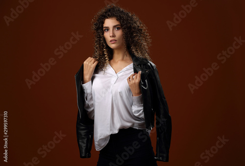 Beautiful girl in white blouse and black leather jacket