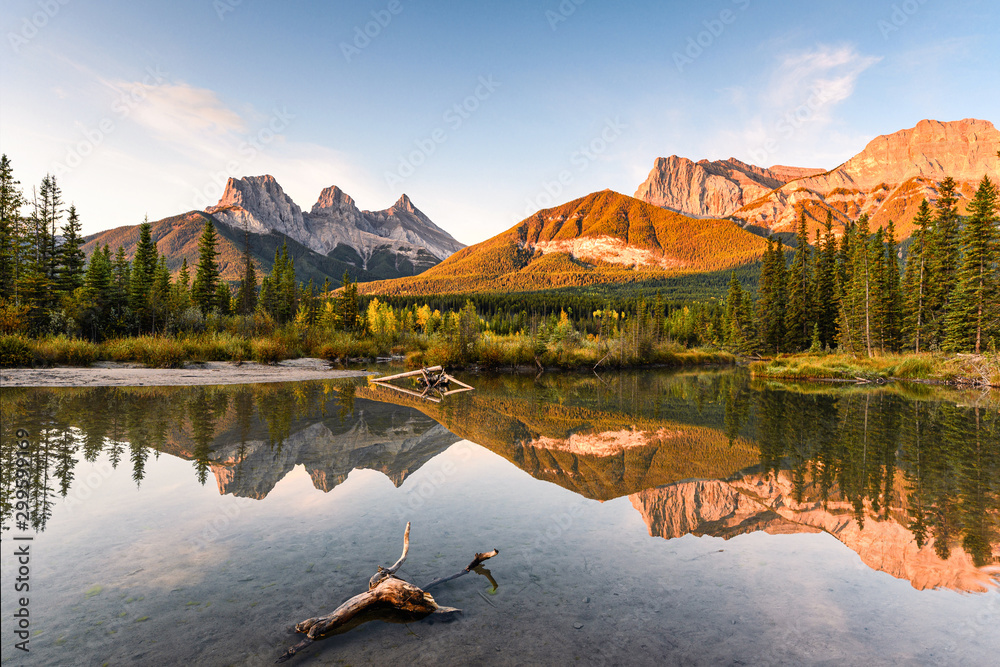 Scenery of Three sisters mountain reflection on pond at sunrise in autumn at Banff national park - obrazy, fototapety, plakaty 