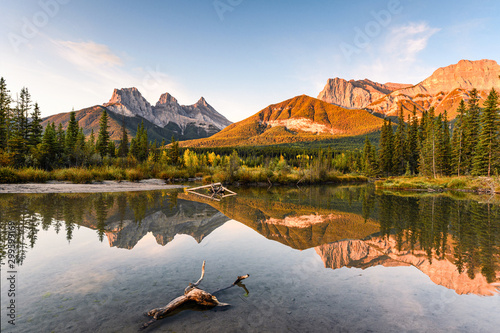 Scenery of Three sisters mountain reflection on pond at sunrise in autumn at Banff national park photo