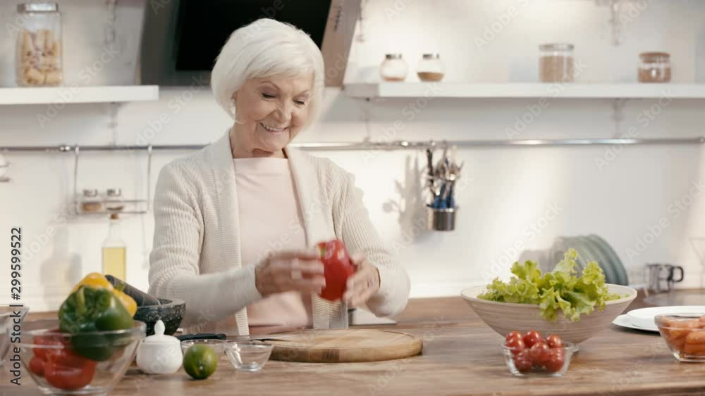 smiling woman throwing and cutting bell pepper smiling woman throwing and cutting bell pepper
