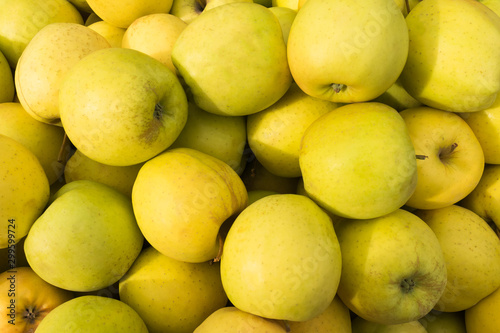 Yellow apples lie on a window of a market, store, supermarket