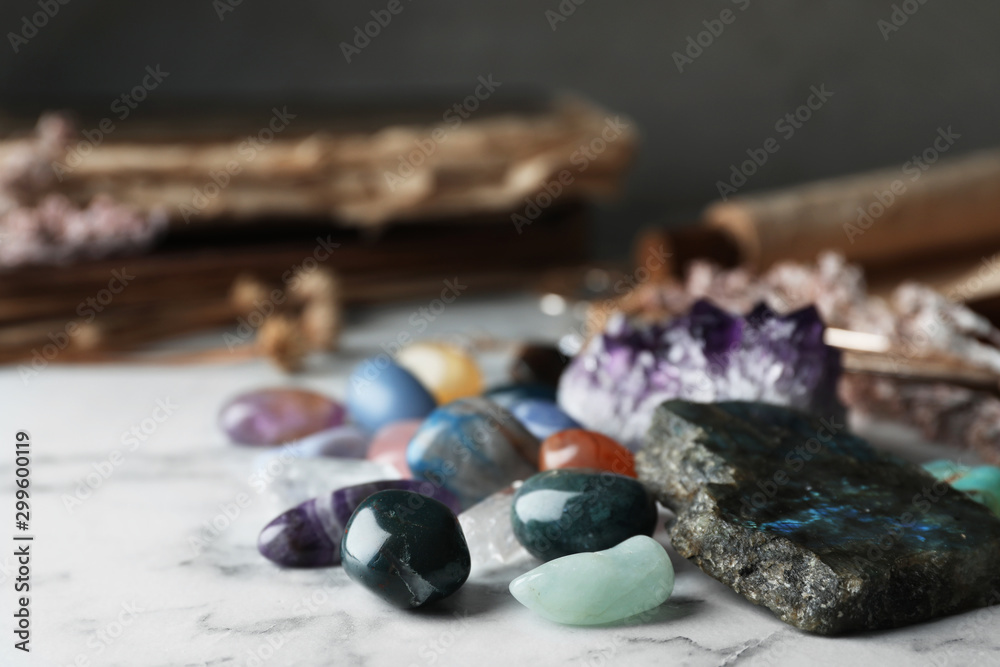 Pile of different beautiful gemstones on marble table Pile of different beautiful gemstones on marble table