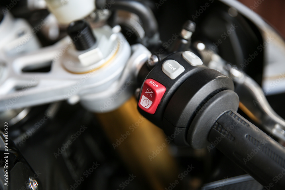 part of a sport bike close up. red button of start or stop engine of  motorcycle. buttons on the right handle of superbike's handlebar Stock-Foto  | Adobe Stock