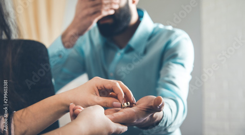 woman hand ring with angry man in home