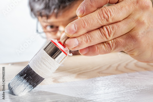 Applying white primer paint on wood