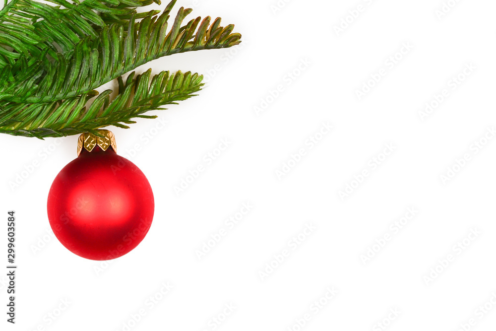 A sprig of spruce decorated with red Christmas ball isolated on white. A sprig of spruce decorated with red Christmas ball isolated on white.
