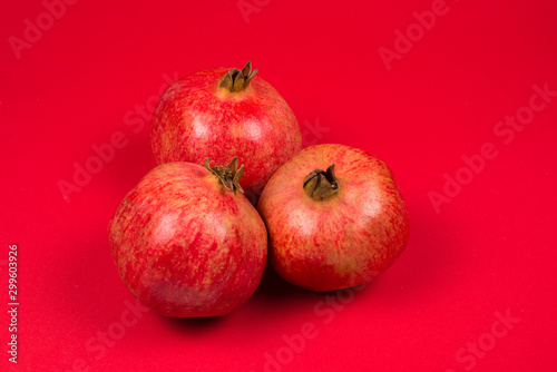 Sweet pomegranate on red background.