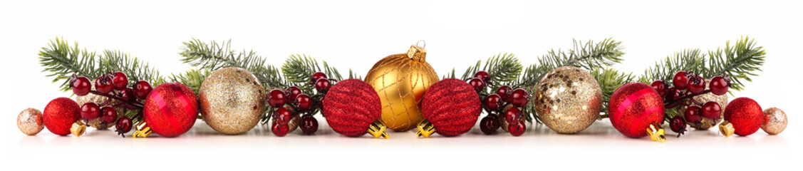 Christmas border of red and gold ornaments with branches. Side view isolated on a white background.