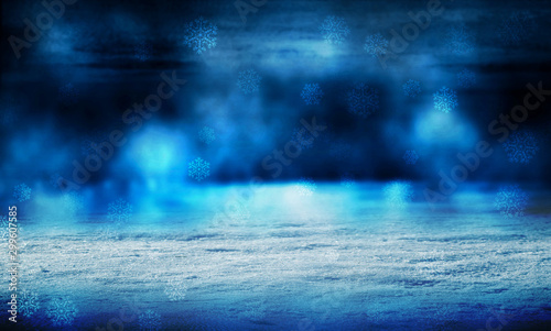 Winter abstract, blurred background with bokeh. Blurry night city lights in reflection on a snowy road. Neon light, falling snow, snowflakes.