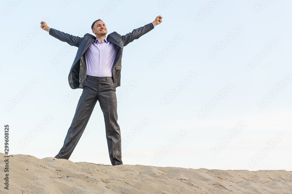 Handsome man elegantly dressed walking the desert Handsome man elegantly dressed walking the desert