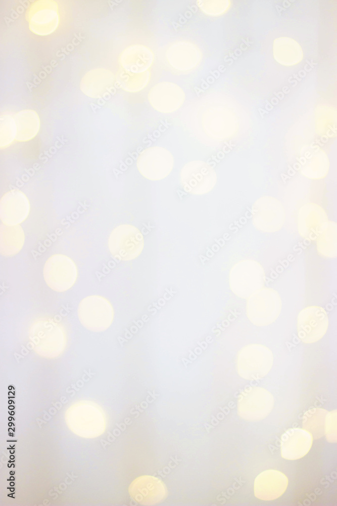 Blurred wooden white background with warm bokeh lights. Wooden background with yellow bokeh bulbs. Selective focus. Blurred wooden white background with warm bokeh lights. Wooden background with yellow bokeh bulbs. Selective focus.