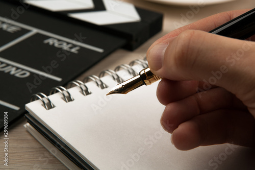 fountain pen in the hands of a screenwriter photo