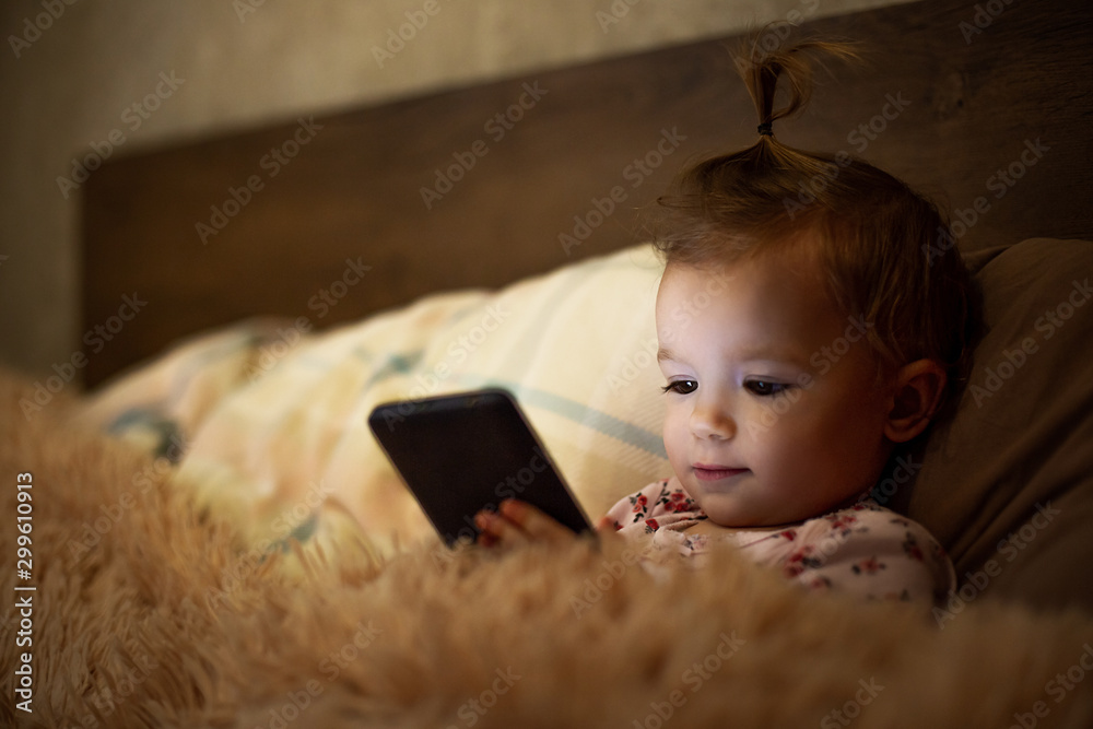 parental problems in parenting. A little kid has a gadget addiction, plays gadgets all the time, watches videos on a smartphone and falls asleep with only the phone in his hands parental problems in parenting. A little kid has a gadget addiction, plays gadgets all the time, watches videos on a smartphone and falls asleep with only the phone in his hands