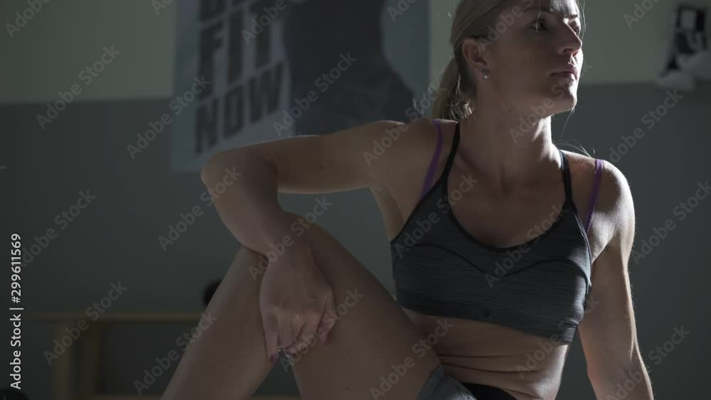 Athletic woman doing stretching exercises