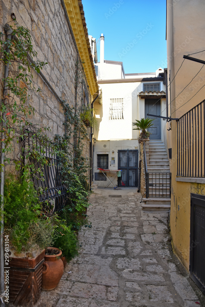 Venosa, Italy, 10/27/2019. A narrow street among the old houses of a medieval village