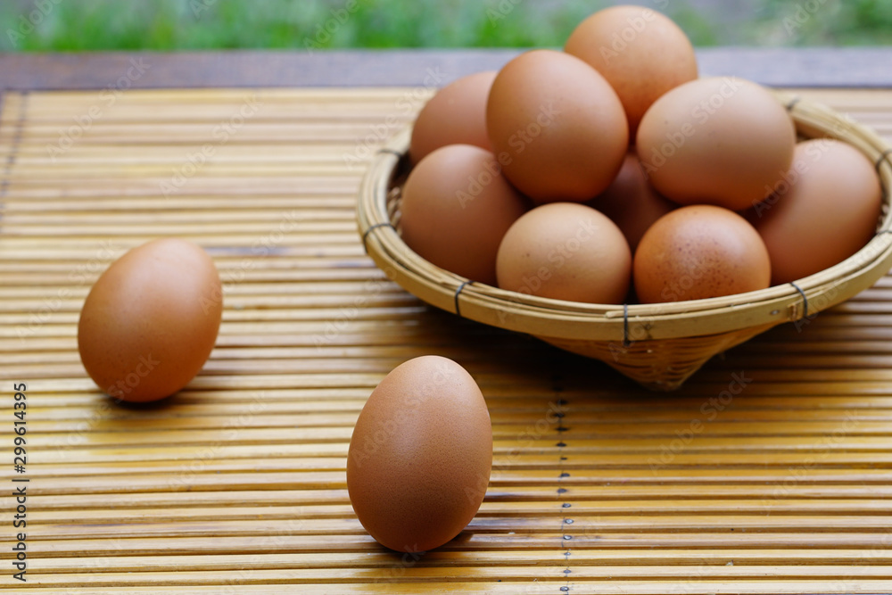 Eggs in basket with wood table background Eggs in basket with wood table background