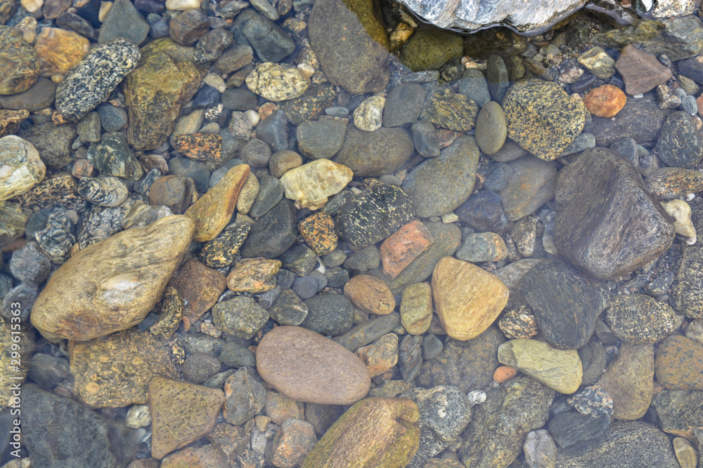 Background of shiny pebbles on the river bottom. Background of shiny pebbles on the river bottom.